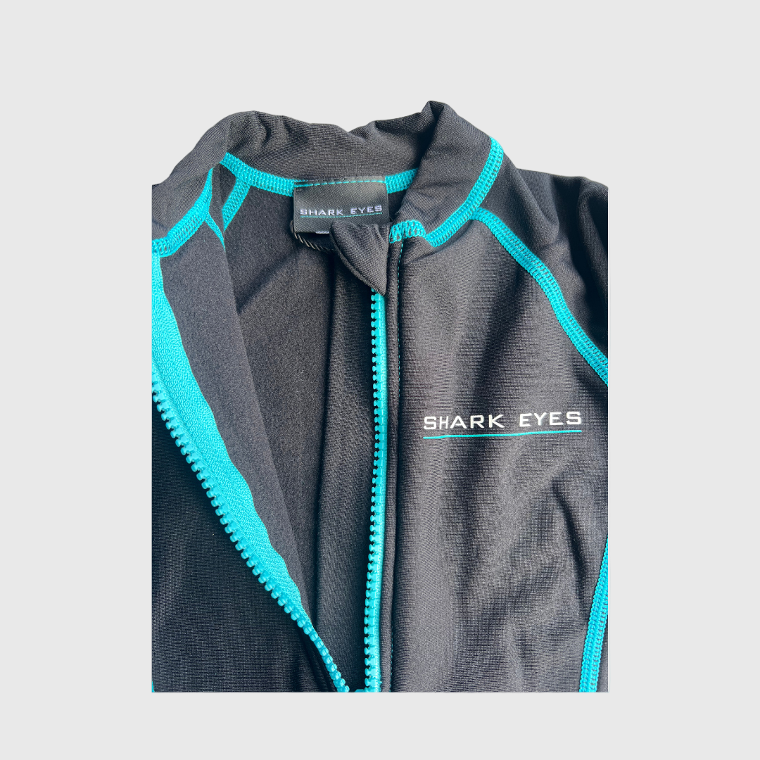 Black Toddlers Thermal Springsuit with turquoise zipper and 'Shark Eyes' branding on a gray background