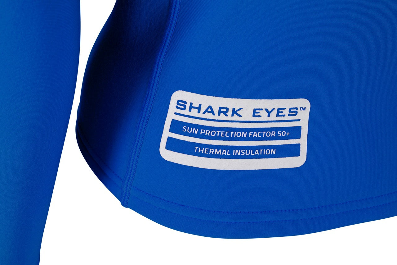 Groms surfing in Shark Eyes thermal rash vest, blue — warm rashie for cold water