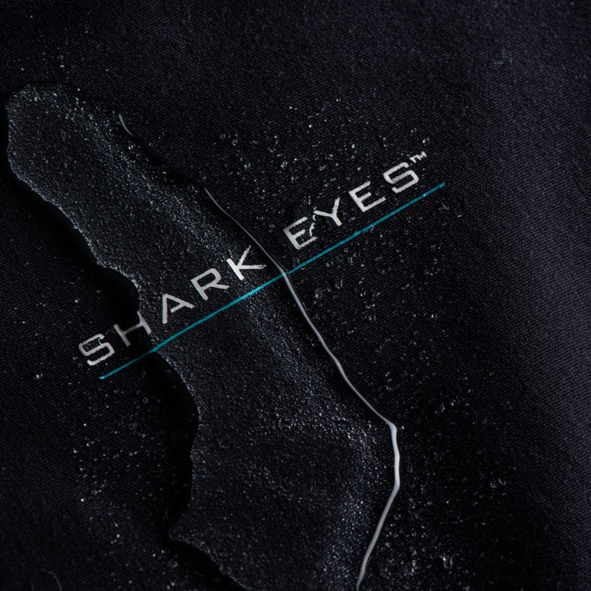 Mens wearing Shark Eyes thermal rash vest in cold water — surfing