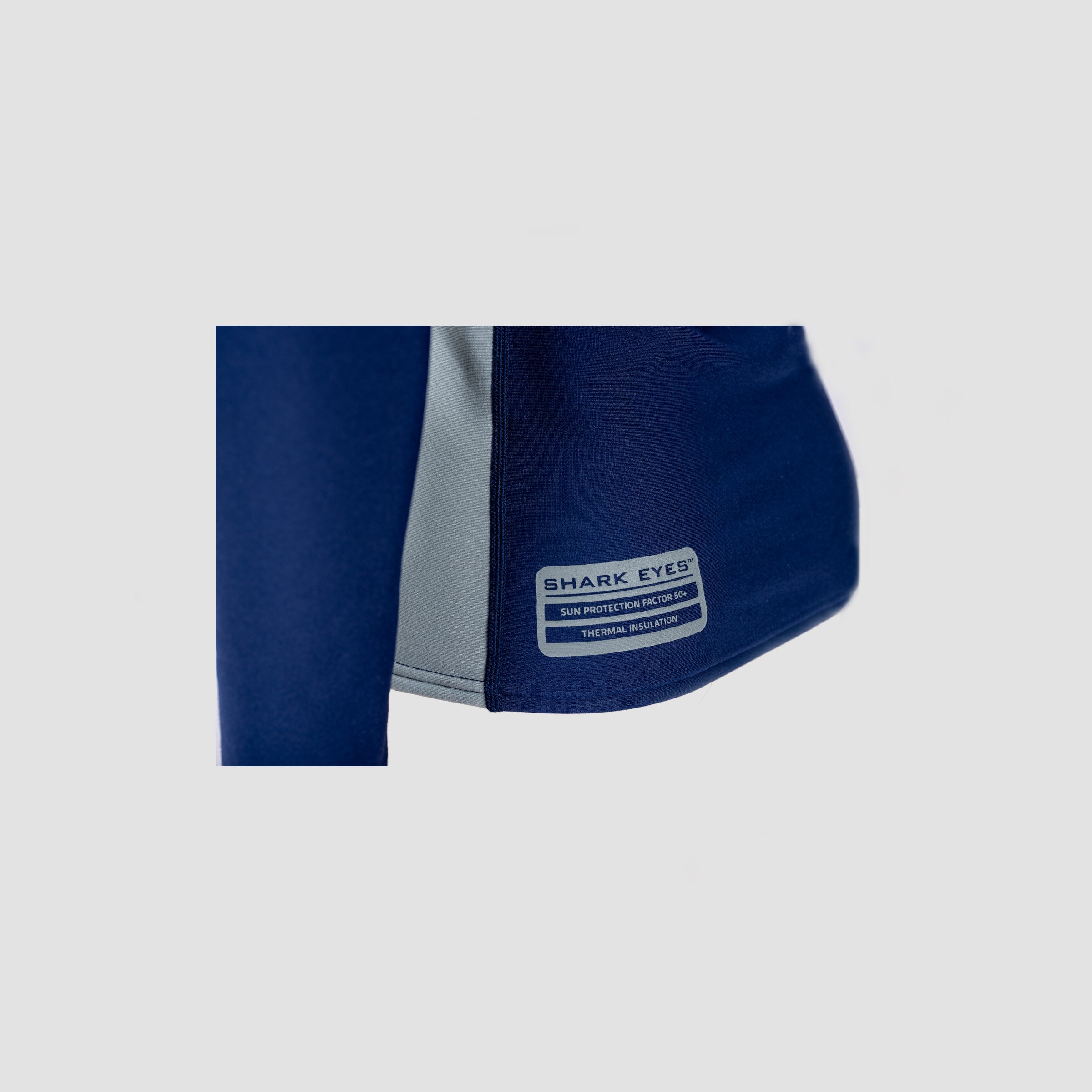 Close-up of brand tag on Shark Eyes womens thermal rash vest — quality rashie, AU made