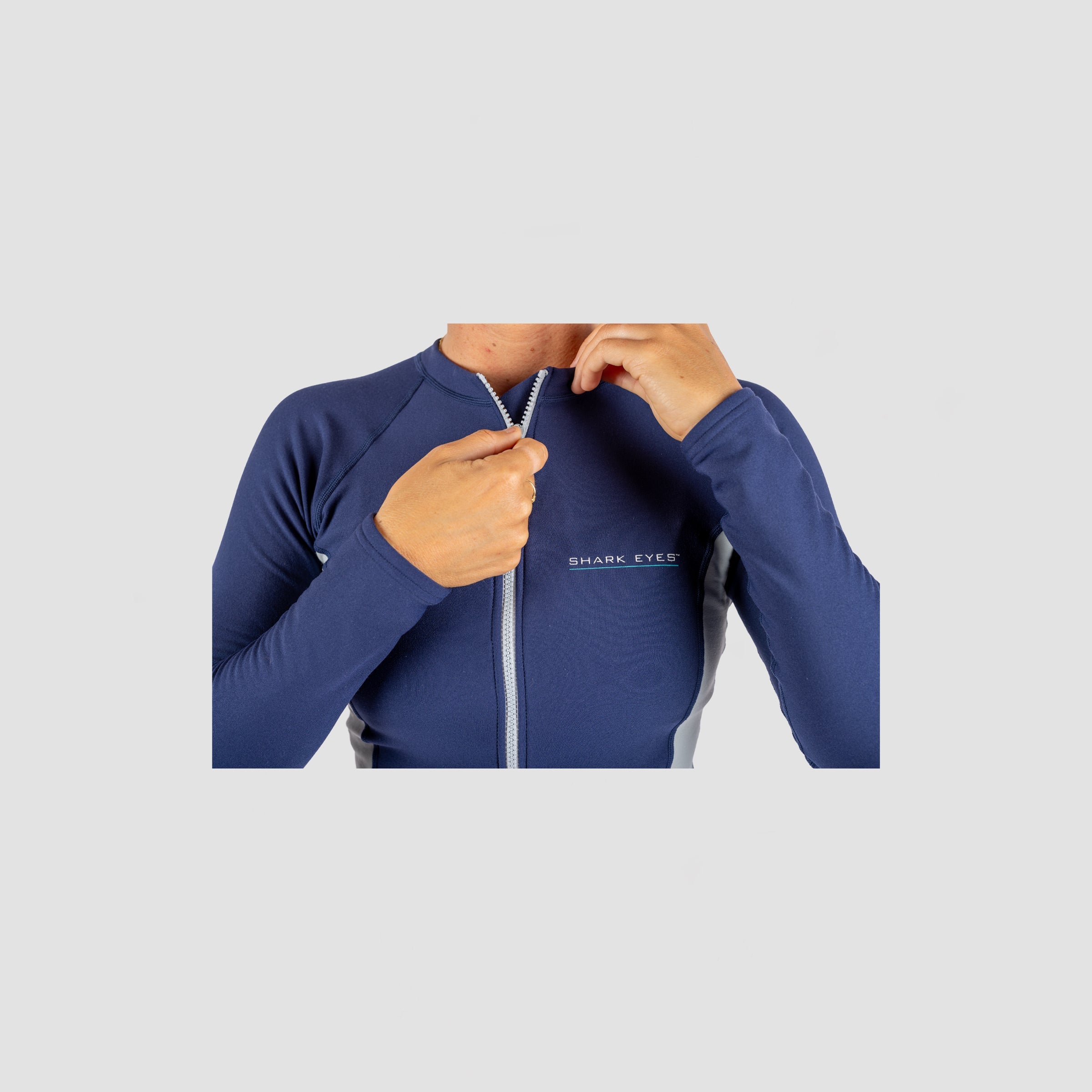 Womens wearing Shark Eyes thermal rash vest in cold water — surfing