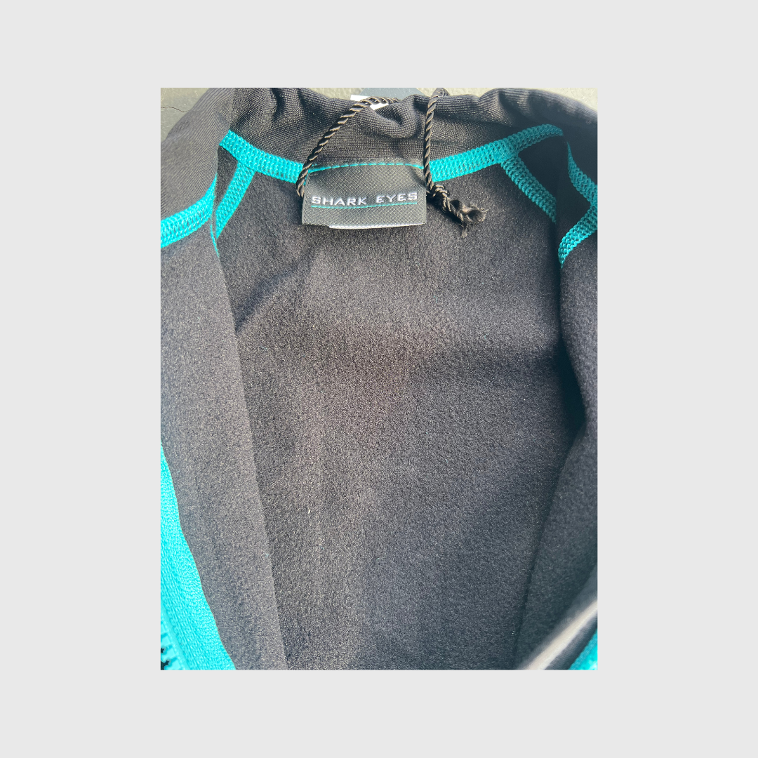 Close-up of panel seam on Shark Eyes groms thermal springsuit — flatlock stitching detail