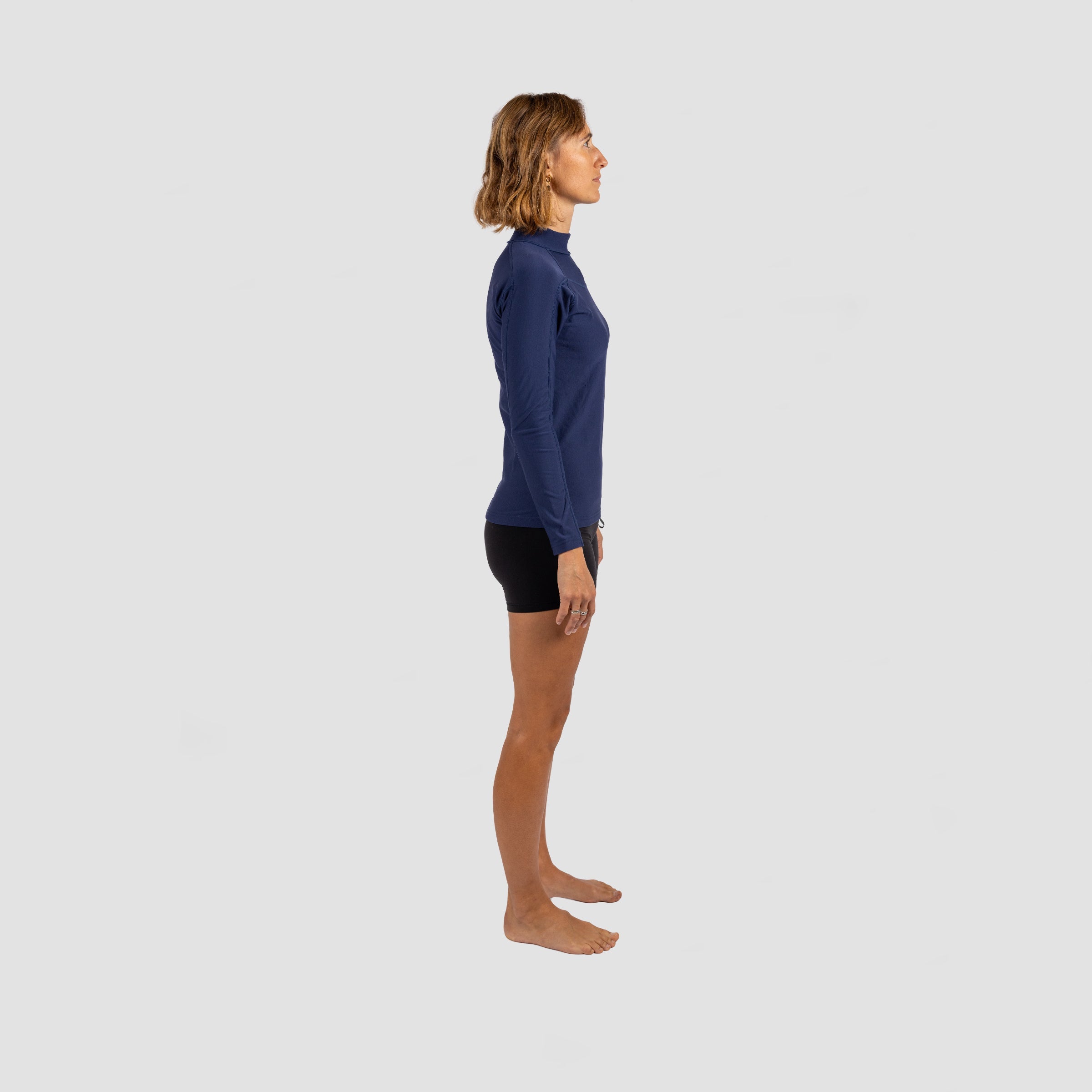 womens warming up in Shark Eyes thermal rash vest — cold water surfing gear