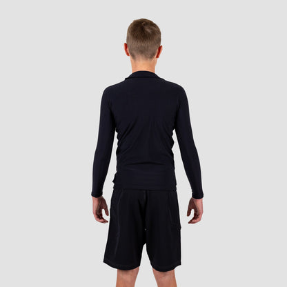 Youth wearing Shark Eyes thermal rash vest in cold water — surfing