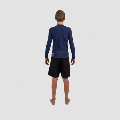 Youth in Shark Eyes thermal rash vest, back view — cold water surfing
